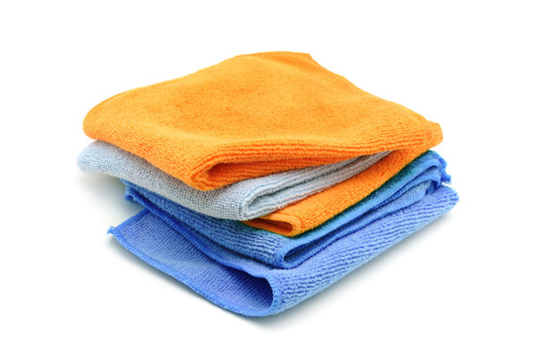 Colorful microfiber cleaning towels isolated on a white background.